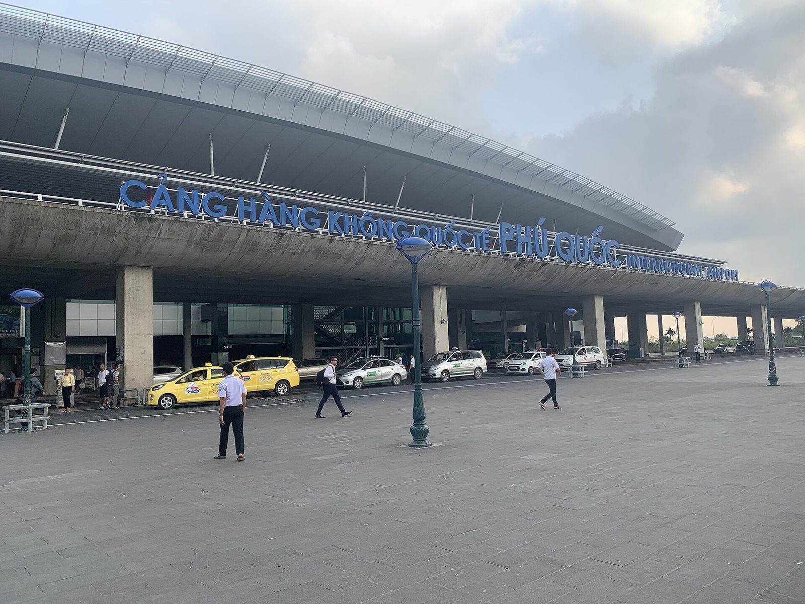 The terminal front at Phu Quoc International Airport, with the control tower and a line of taxis