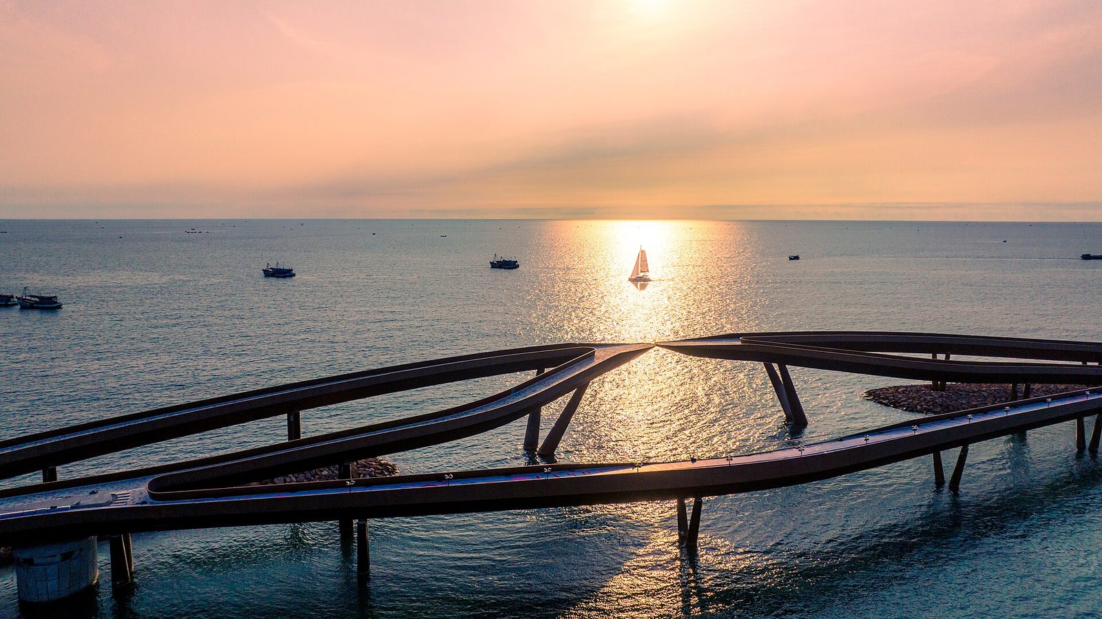 Kiss Bridge at Sunset Town, Phu Quoc, curving over the water at dusk