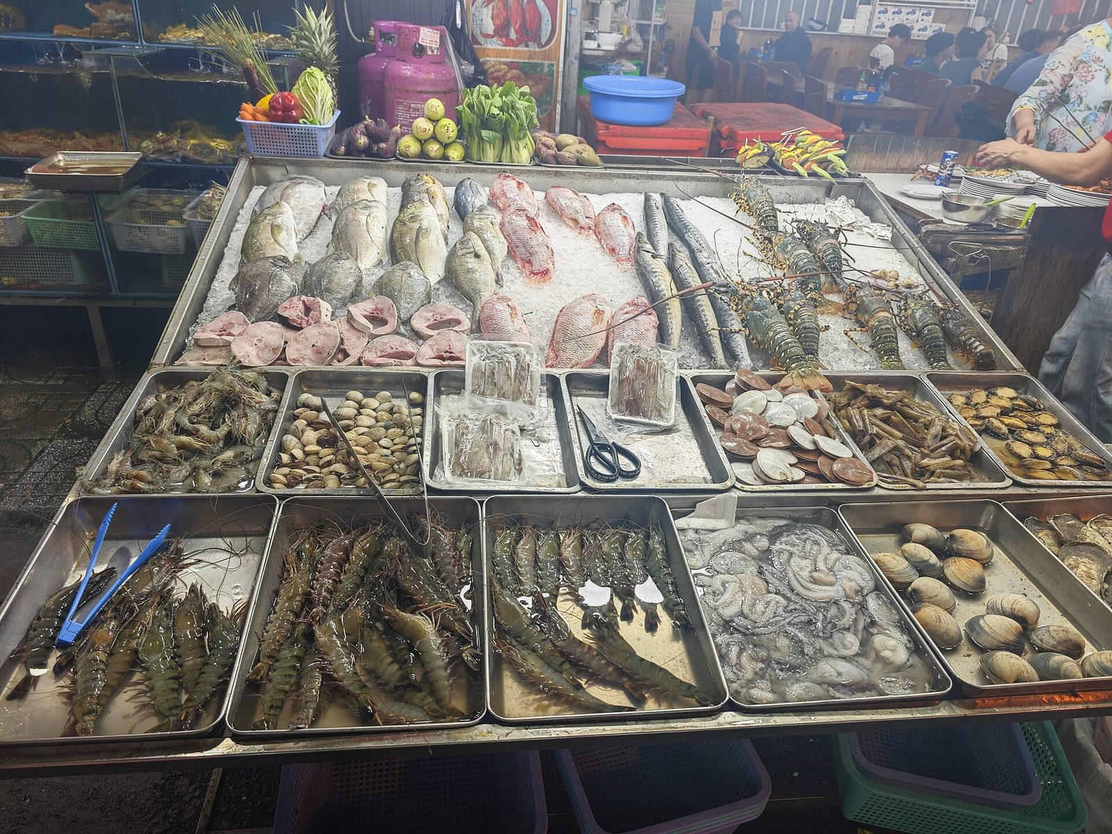 Grilled fish on banana leaves at a Duong Dong night market stall in Phu Quoc