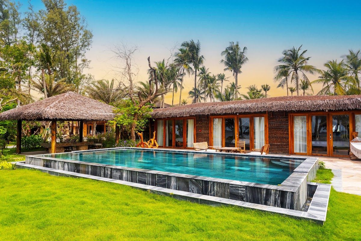 Salinda-style infinity pools on mid-Long Beach face west for sunset views The infinity pool at a boutique Long Beach resort overlooks calm Gulf of Thailand water in the early evening