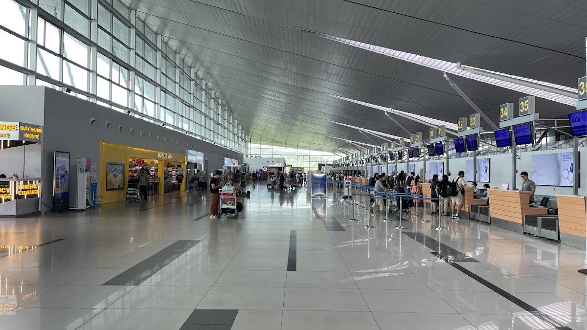 Phu Quoc International Airport (PQC) terminal interior with check-in desks and travellers